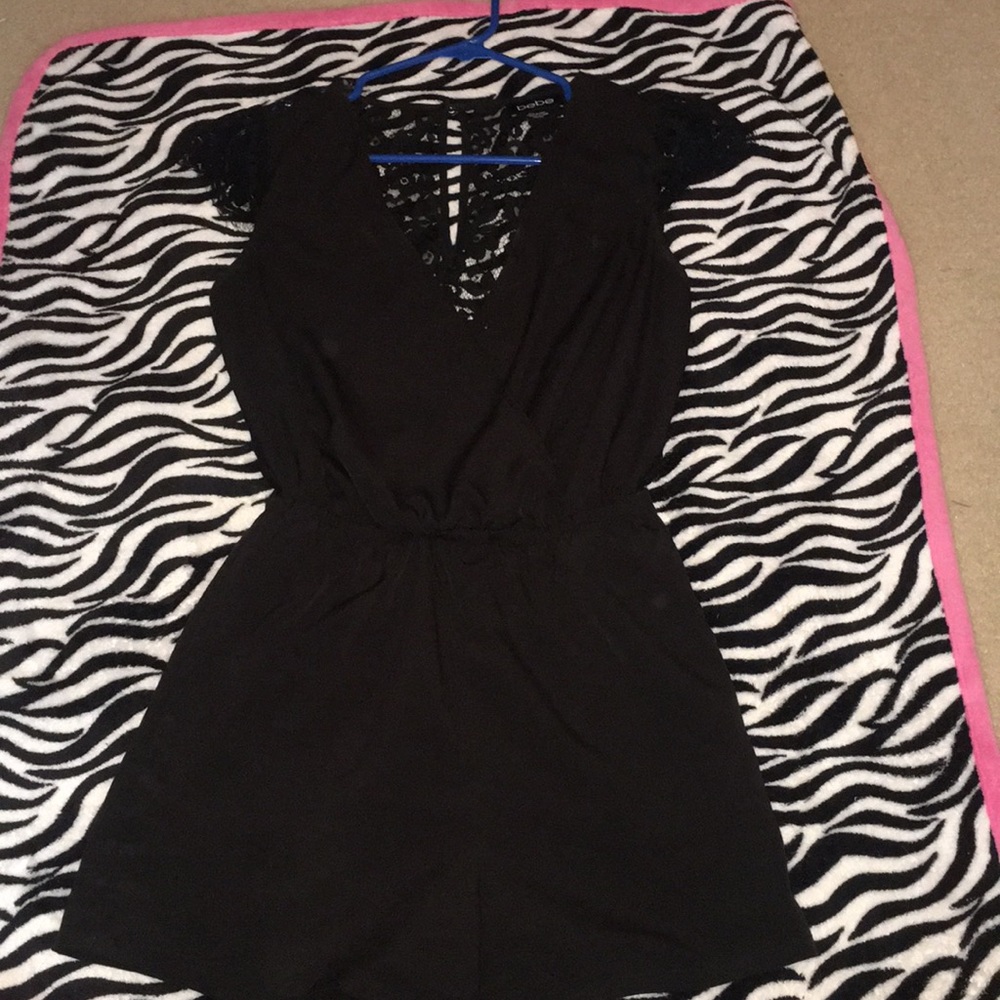 Beautiful BeBe romper with lace on back an sleeves